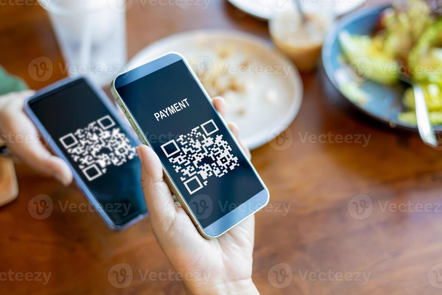 Hands holding mobile phone, Hand using mobile phone application to scan QR code, Qr code payment or cashless technology concept, Coffee shop accepting digital pay without money, Meaningless QR code. photo