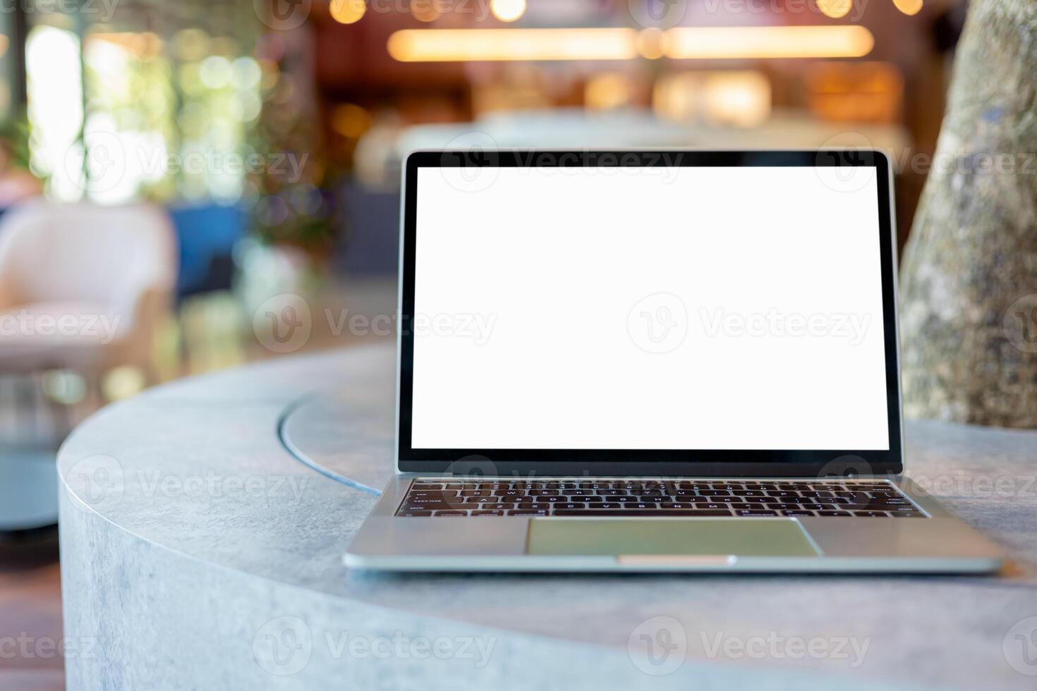 Workspace background new project on laptop computer with blank copy space screen for your advertising text message. Laptop with blank screen and placed on a wooden table inside a coffee shop. photo