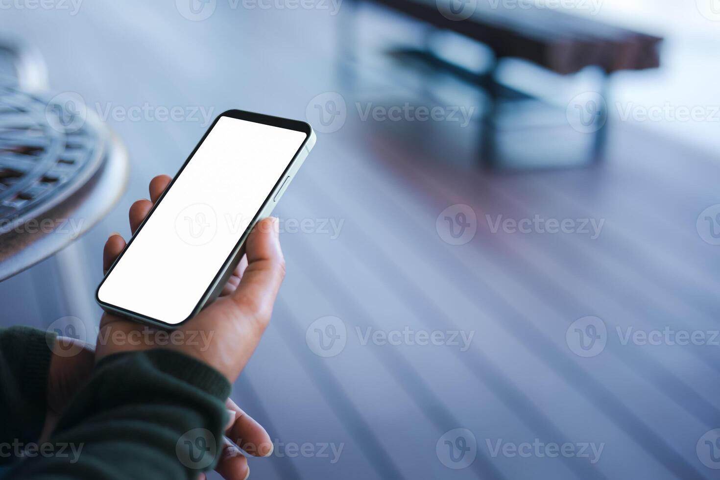 Business woman hand holding smartphone with white empty screen in hand, Smartphone mockup for online shopping, Booking and banking concept, Online education or online business with copy space. photo