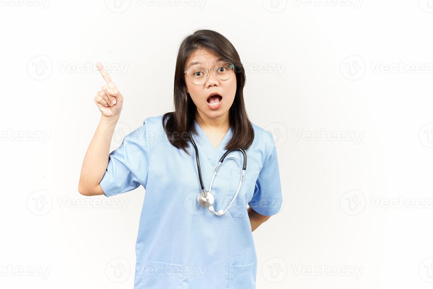Showing Product and Pointing Side Of Asian Young Doctor Isolated On White Background photo