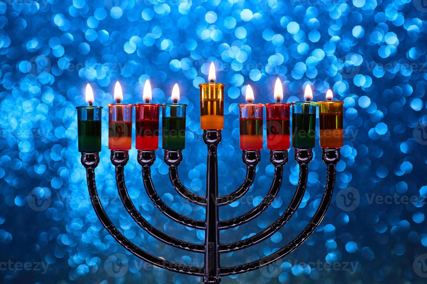 Hanukkah Menorah with burning candles on dark background with bokeh lights. photo