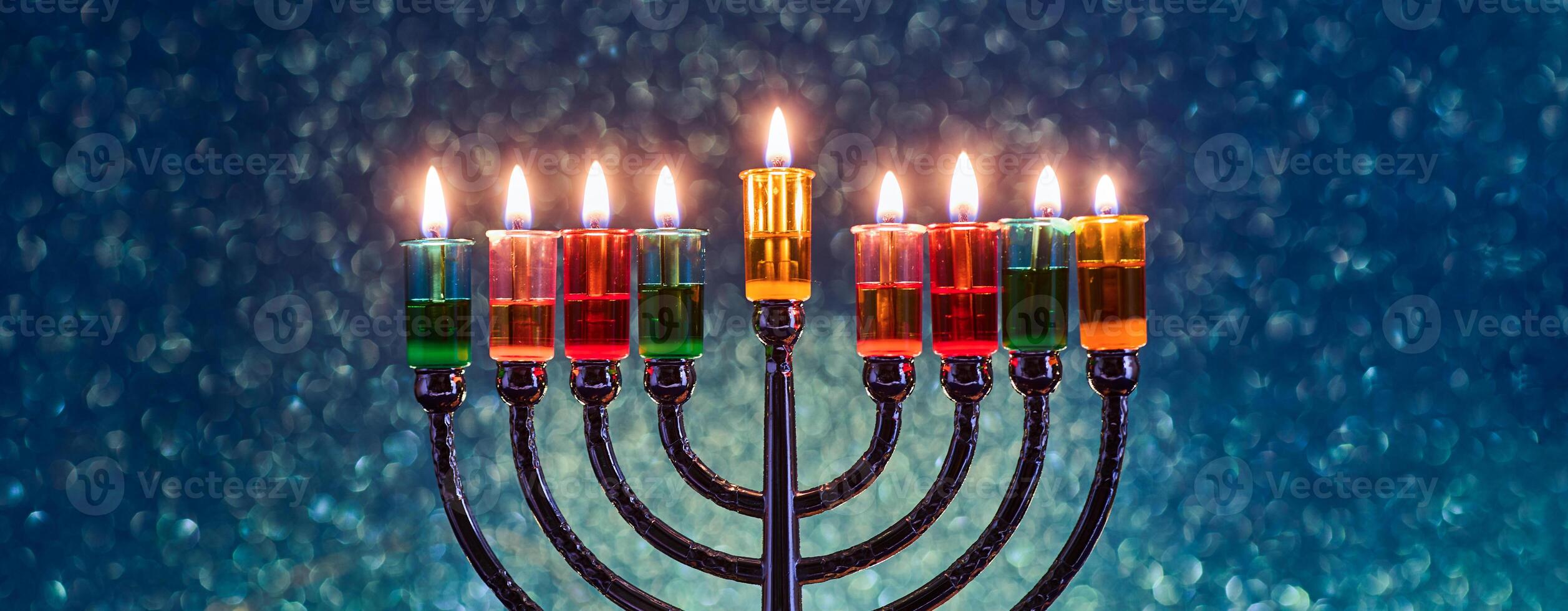 Hanukkah Menorah with burning candles on dark background with bokeh lights. photo