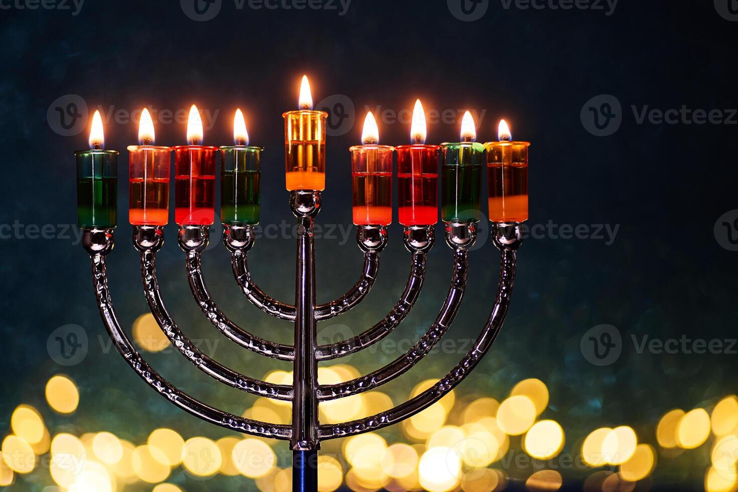 Hanukkah Menorah with burning candles on dark background with bokeh lights. photo