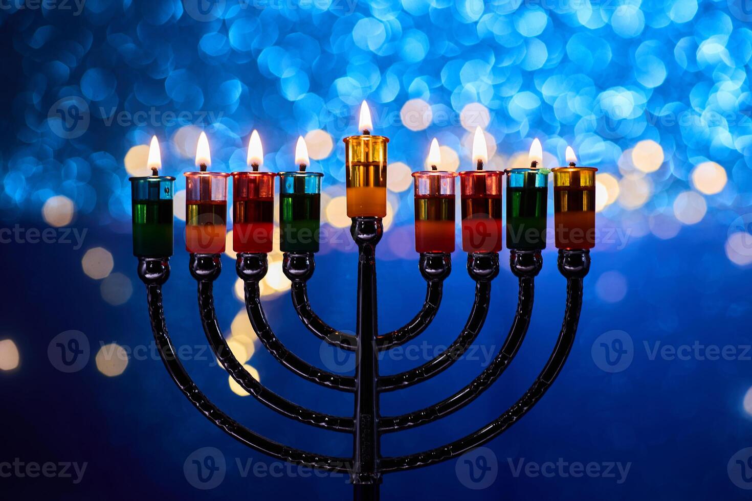 Hanukkah Menorah with burning candles on dark background with bokeh lights. photo