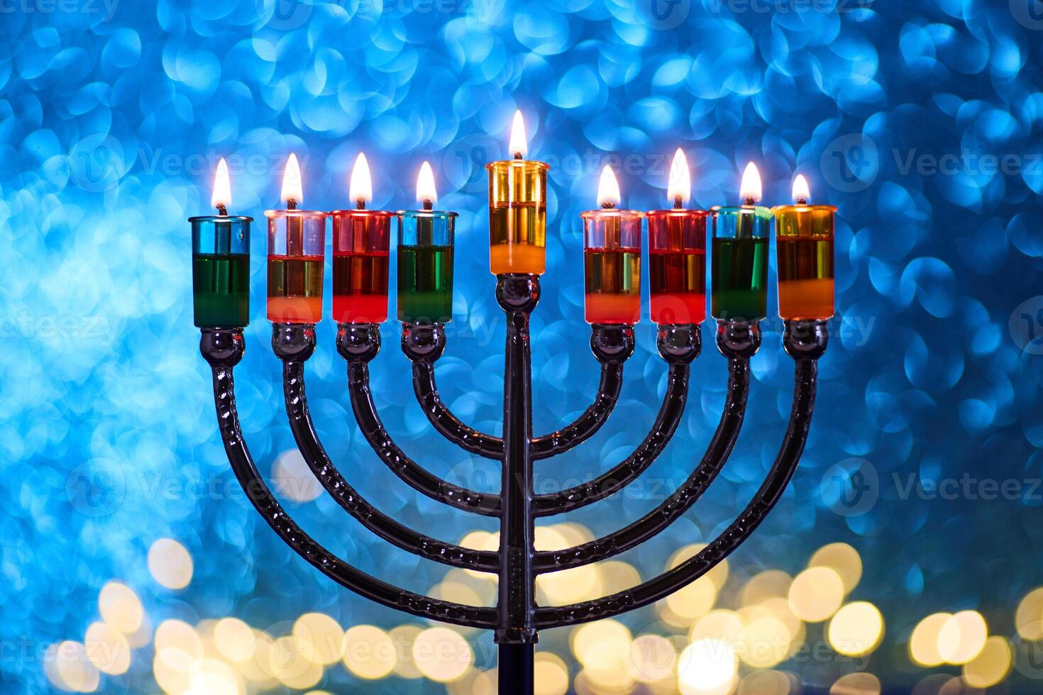 Hanukkah Menorah with burning candles on dark background with bokeh lights. photo