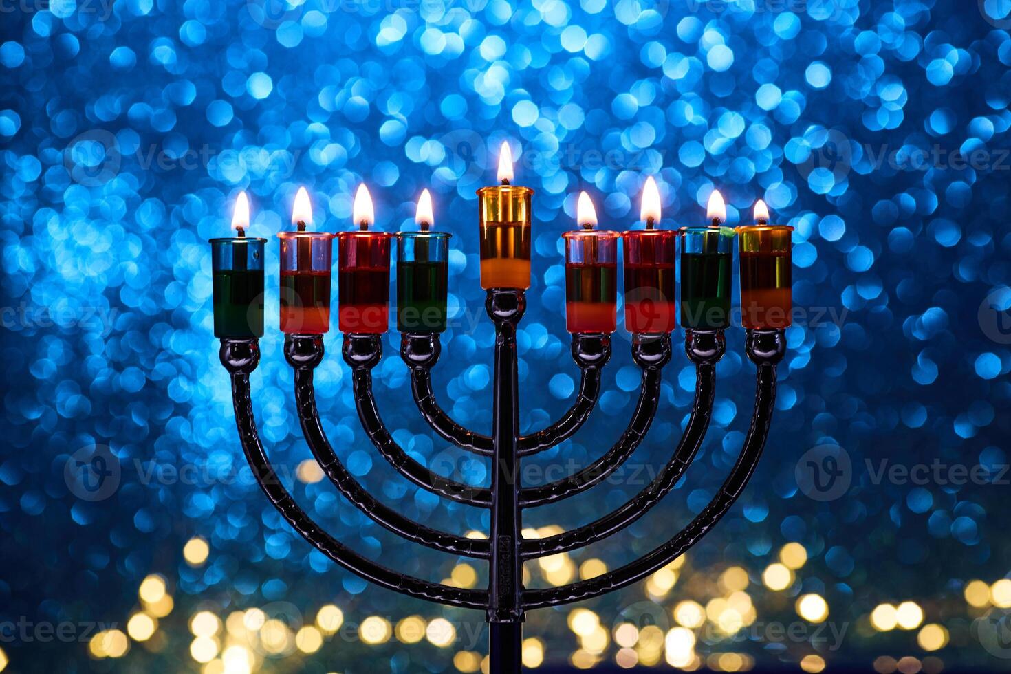 Hanukkah Menorah with burning candles on dark background with bokeh lights. photo