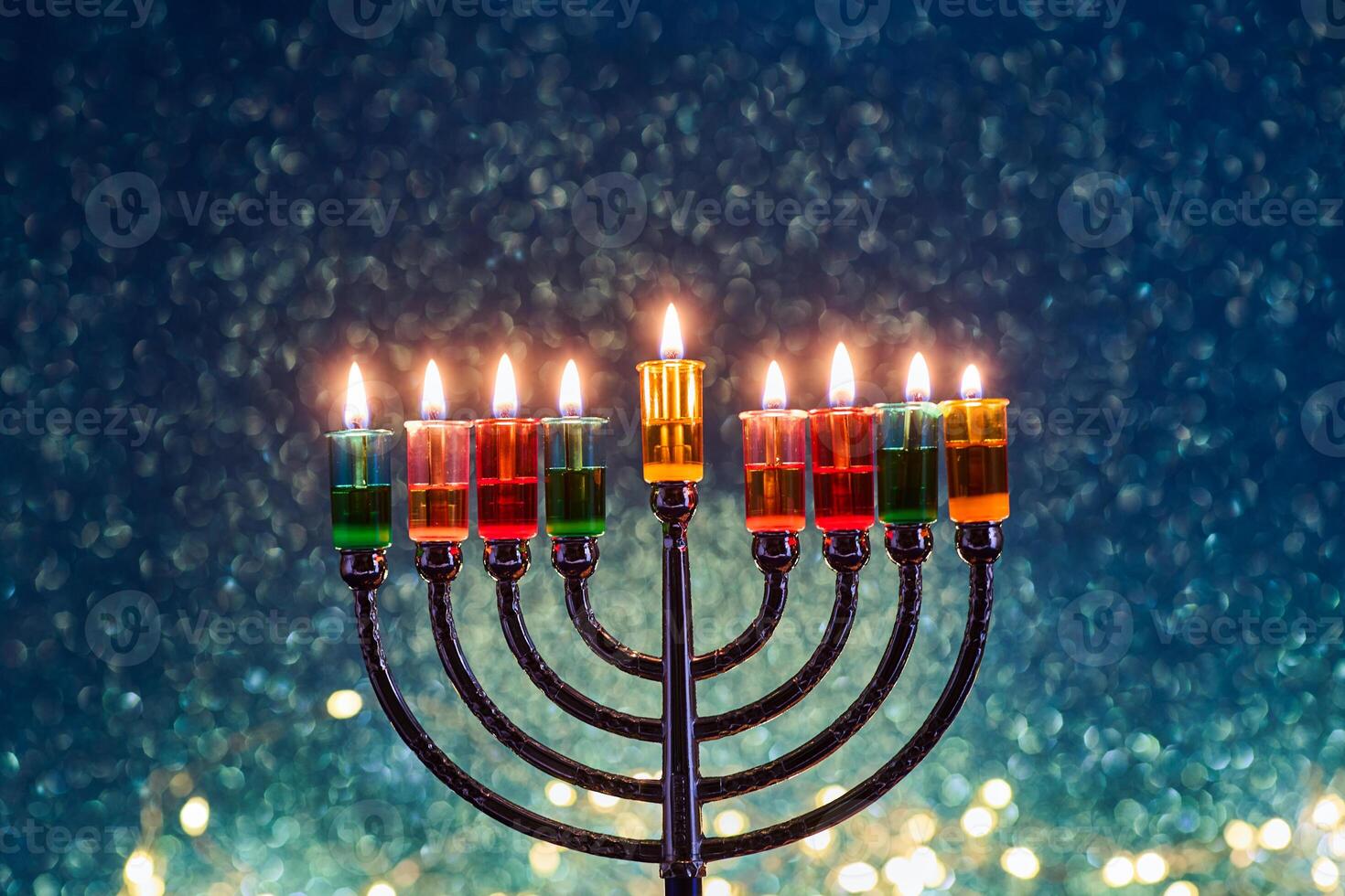 Hanukkah Menorah with burning candles on dark background with bokeh lights. photo