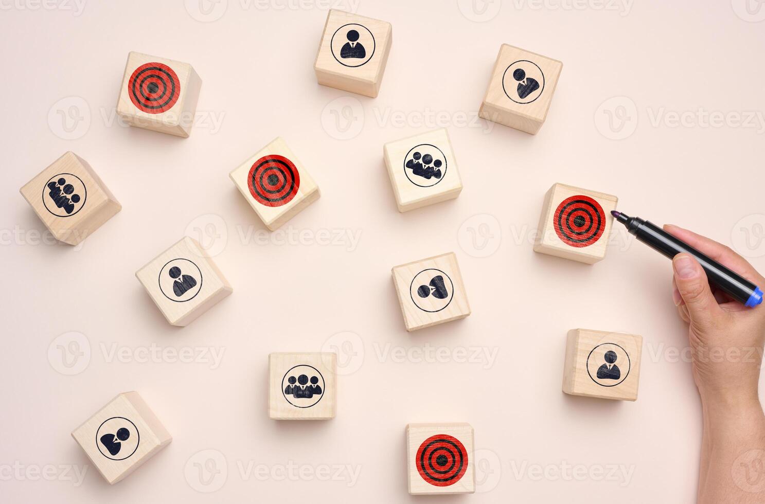 Wooden cubes with staff and goals, search for target audience photo
