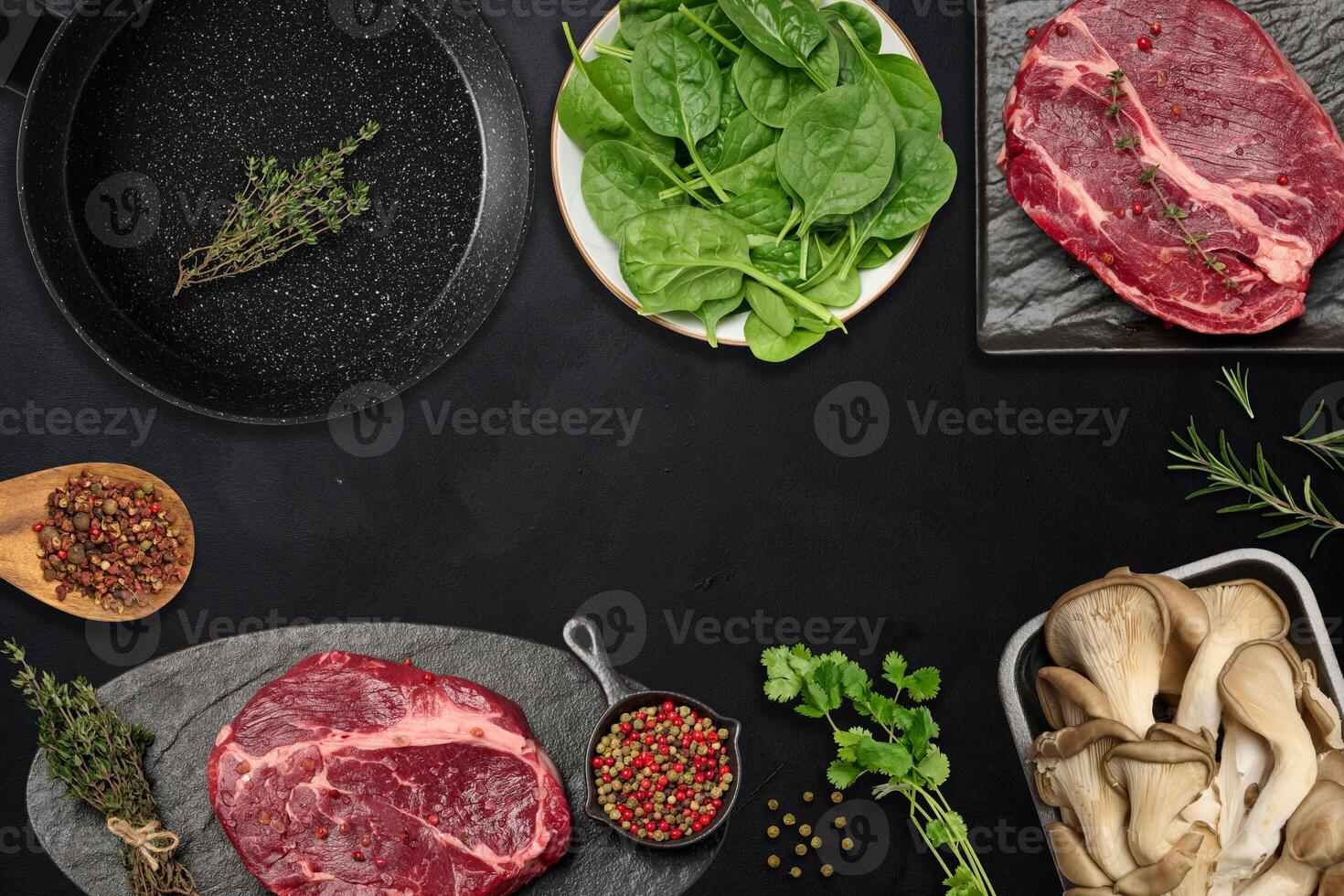 Empty frying pan, raw beef pieces, mushrooms and spices on black table, top view photo