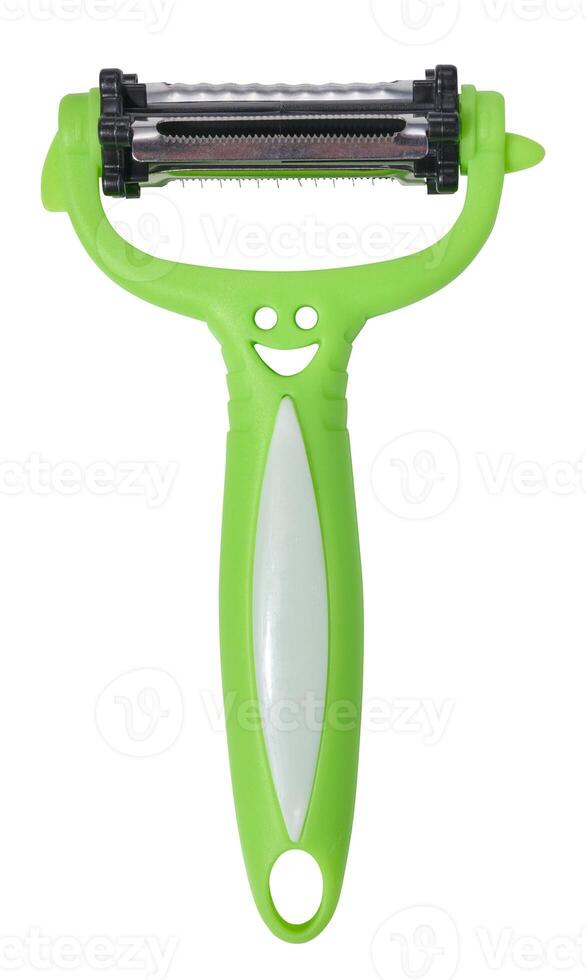 Green plastic vegetable peeler on isolated background photo