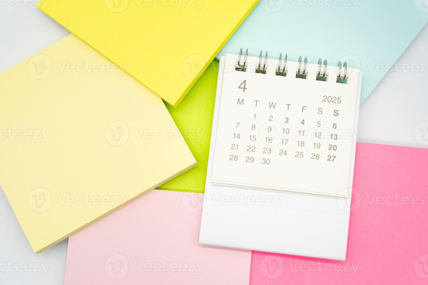 Simple desk calendar for APRIL 2025 with office supplies. Calendar concept with copy space. 2025 APR calendar. photo