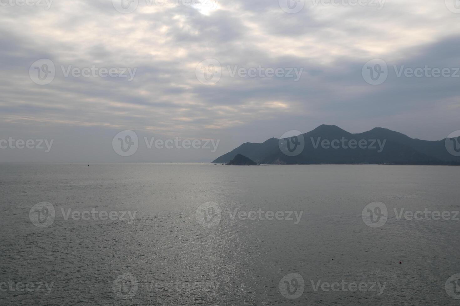 The sea surface is calm, with distant islands and mountains in the distance photo