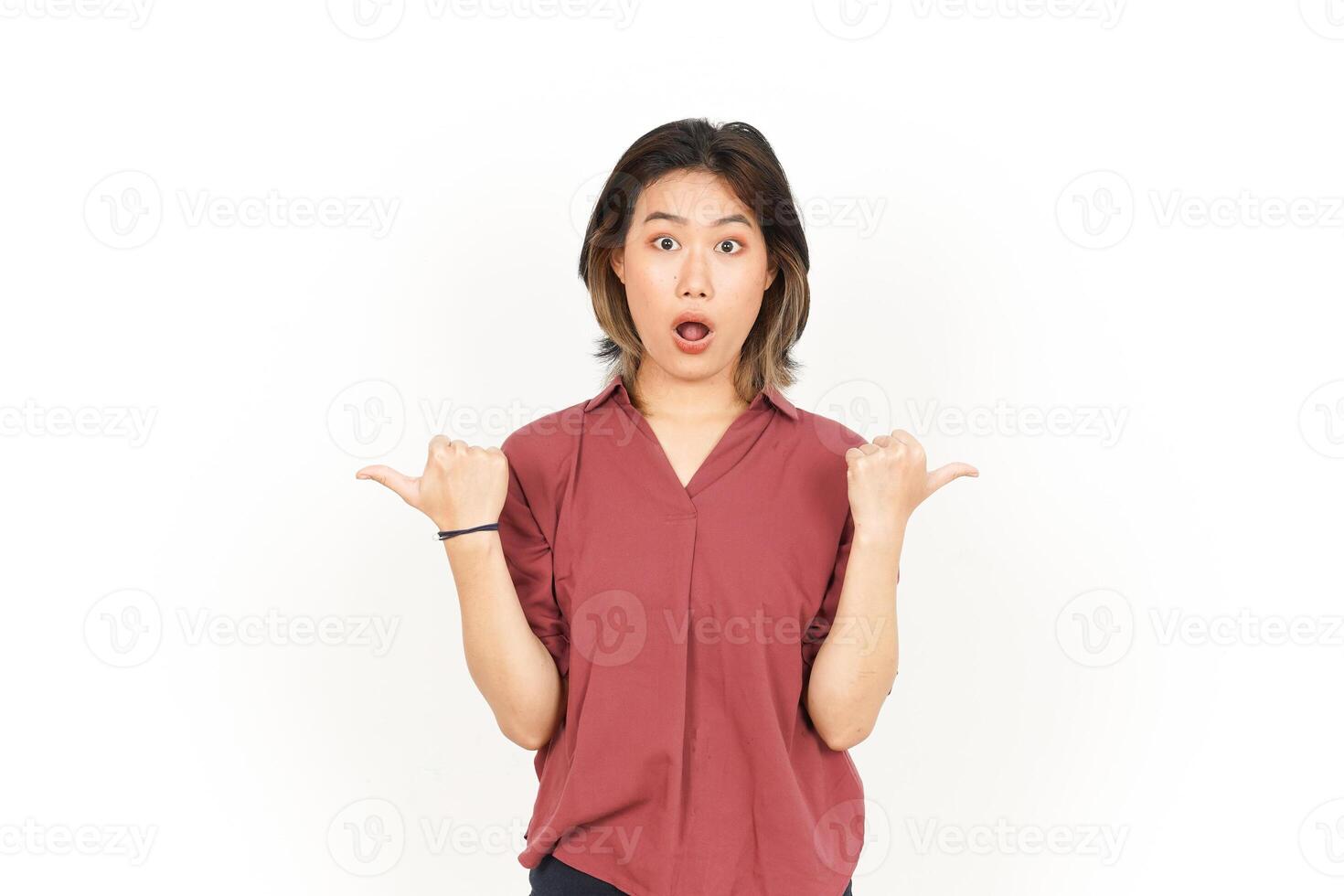 Showing and Pointing Two Product with Thumbs Of Beautiful Asian Woman Isolated On White Background photo