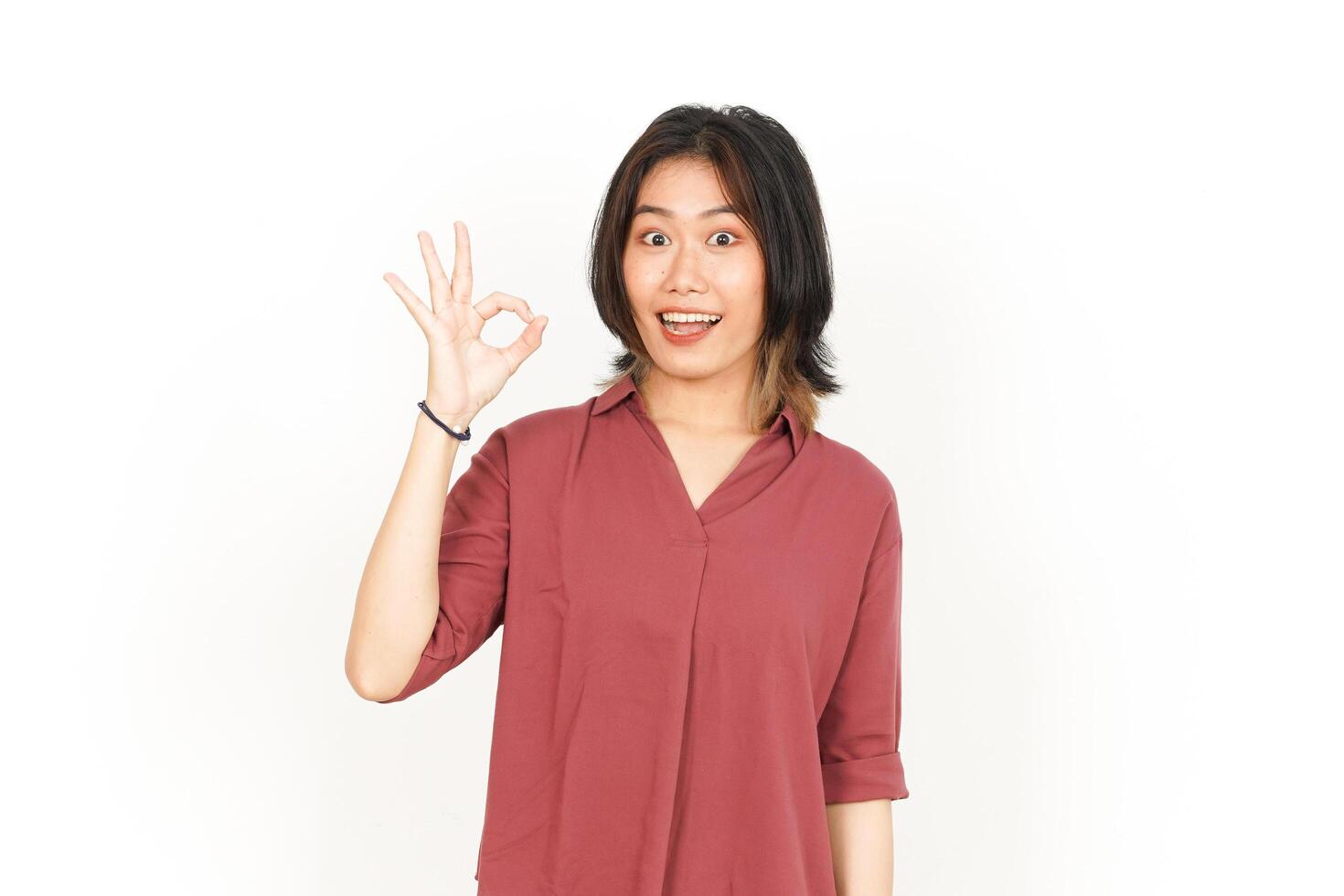 Showing OK Sign Of Beautiful Asian Woman Isolated On White Background photo