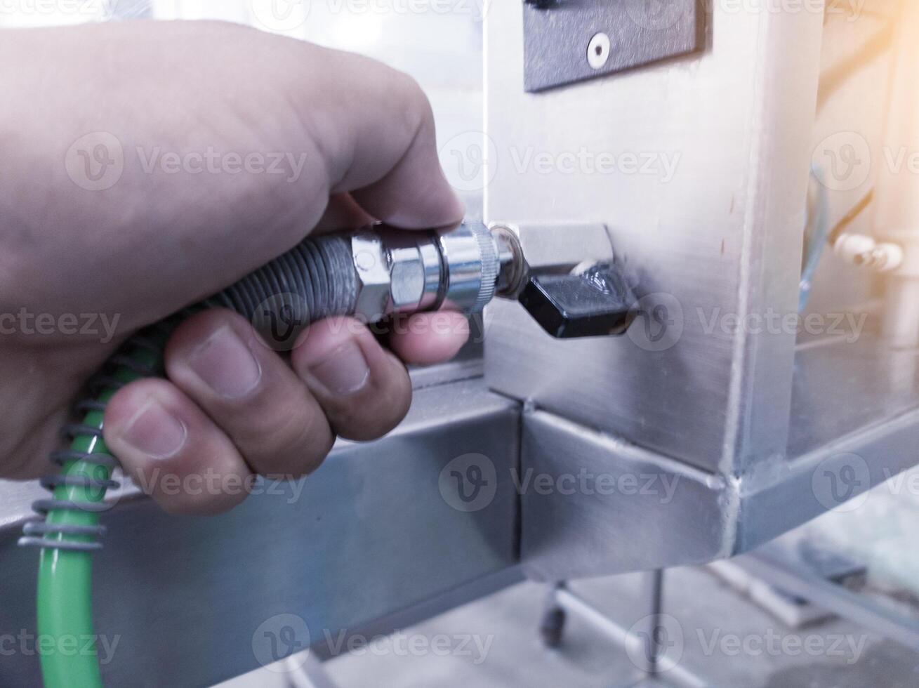 The hand man Connect to quick couplers in air pneumatic system on the manchinery. photo