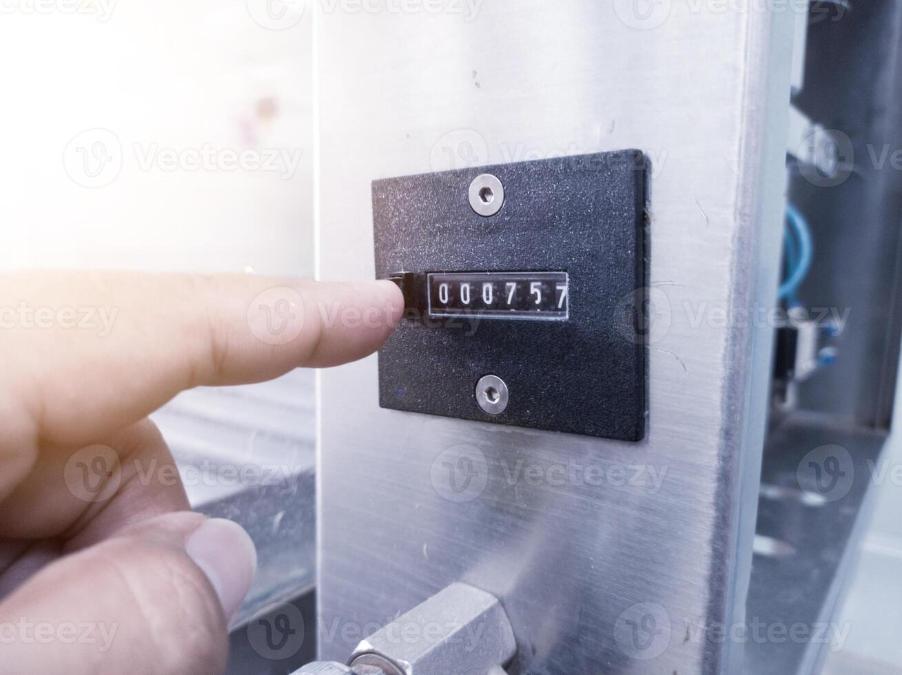 The hand man push the reset counter number on machinery. photo