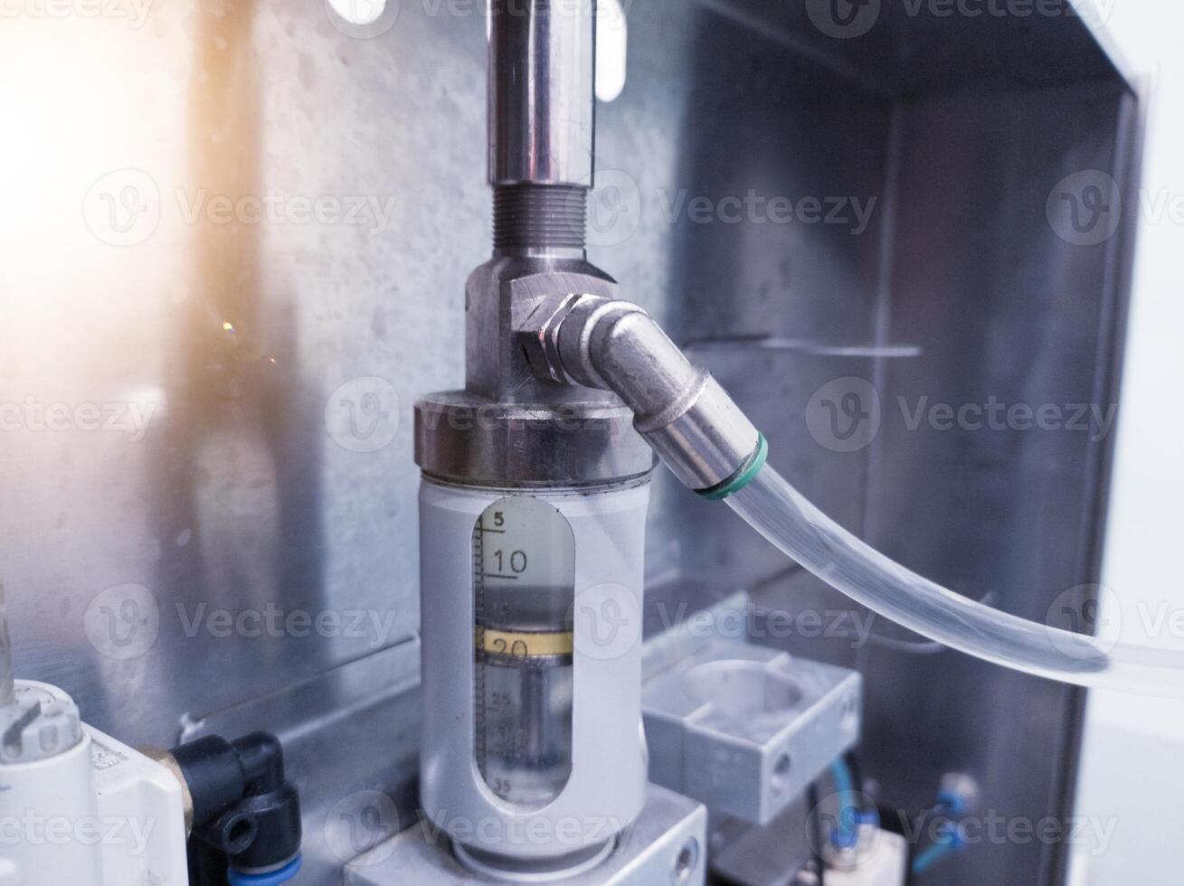 Close up the piston cylinder tube contains medicinal liquid for spray vaccine for hatching chicks. photo