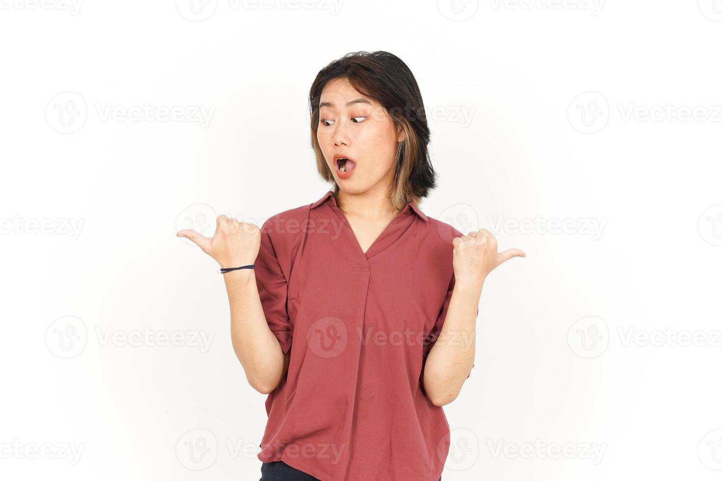 Showing and Pointing Two Product With Thumbs Of Beautiful Asian Woman Isolated On White Background photo
