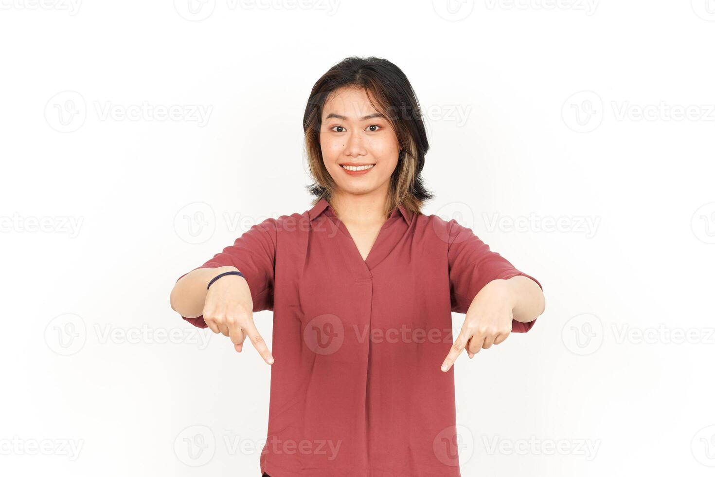 Presenting and Pointing down Product Of Beautiful Asian Woman Isolated On White Background photo