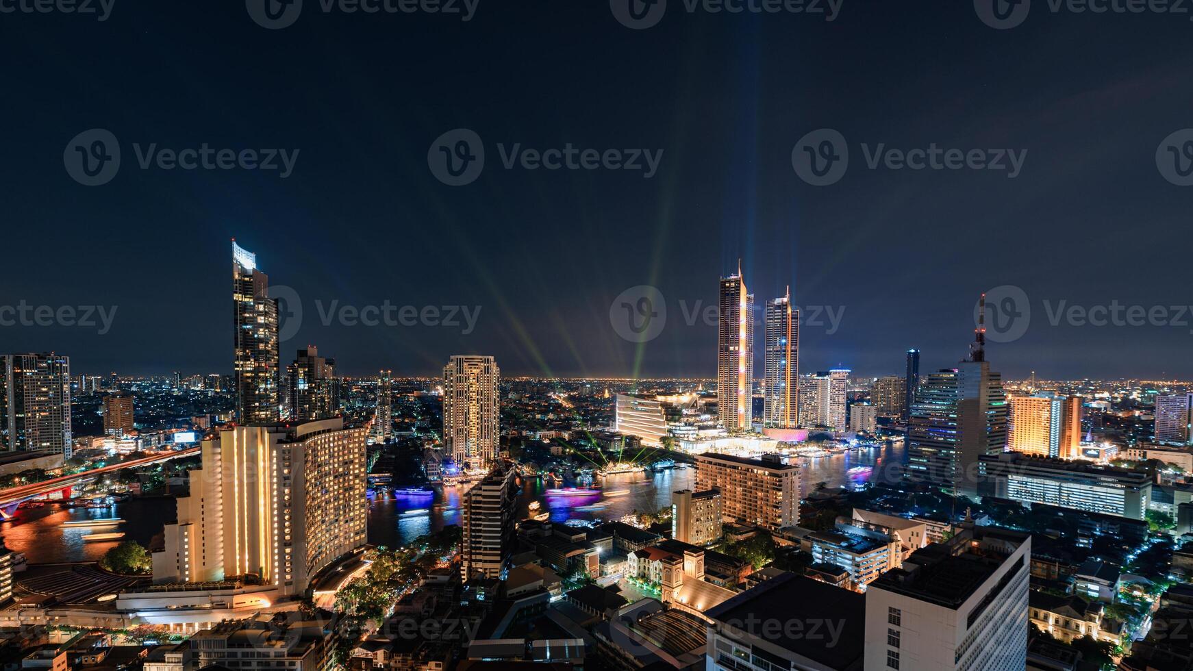 Laser light show with skyscraper and colorful cruise in Chao Phraya riverside at Bangkok photo