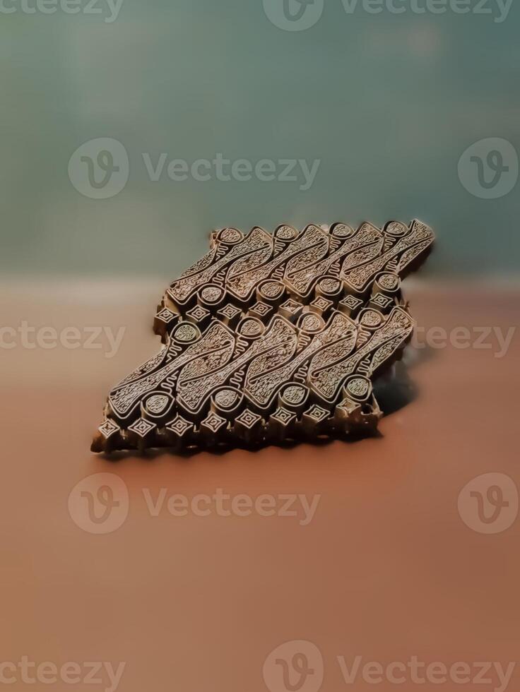 A close up of a Javanese batik copper stamp with an intricate geometric pattern. photo