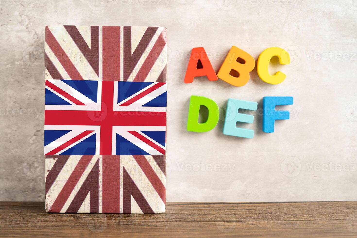 Word English on book with United Kingdom flag, learning English language courses concept. photo