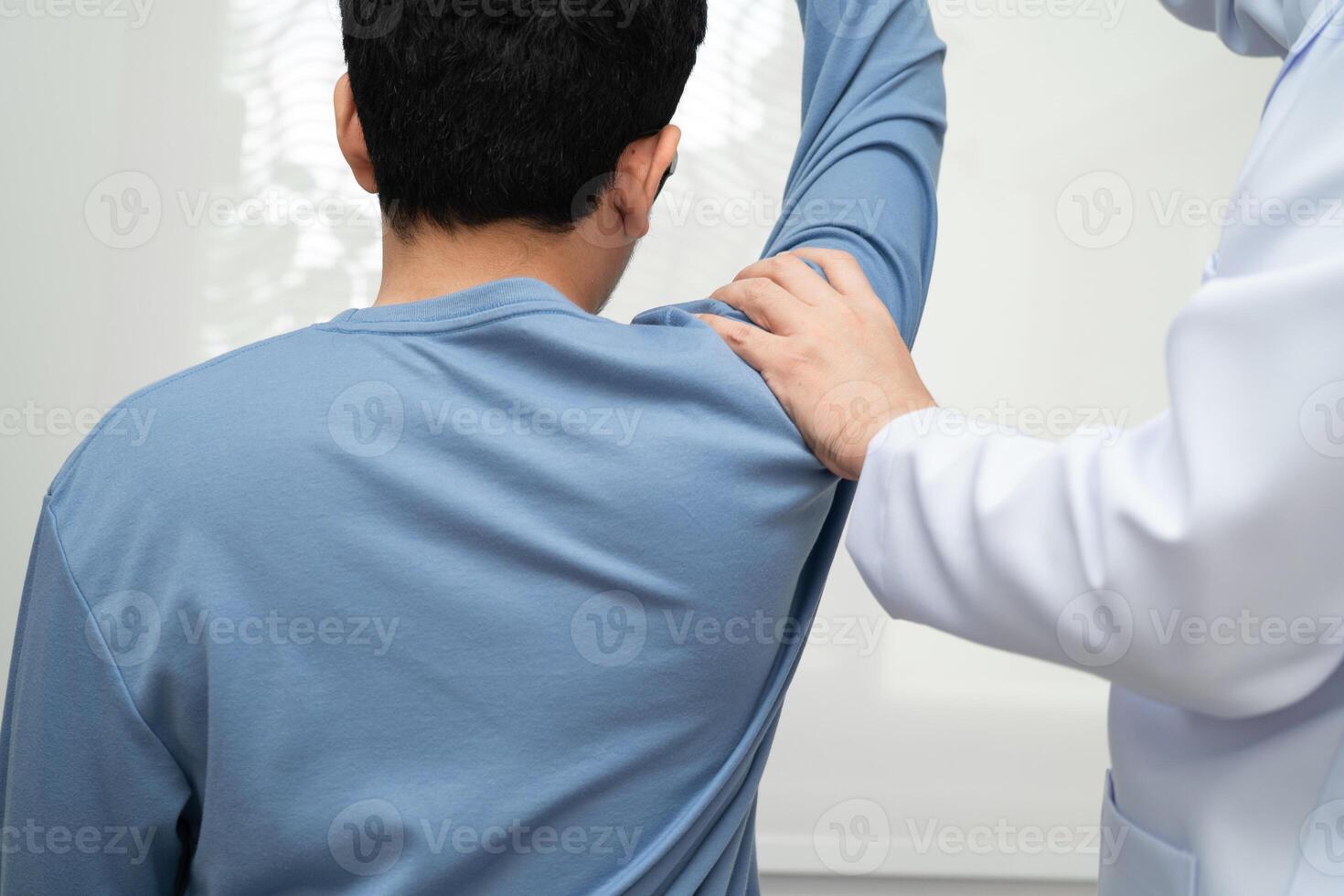 Physical therapy, Asian therapist doctor treat perform pain young man in hospital. photo