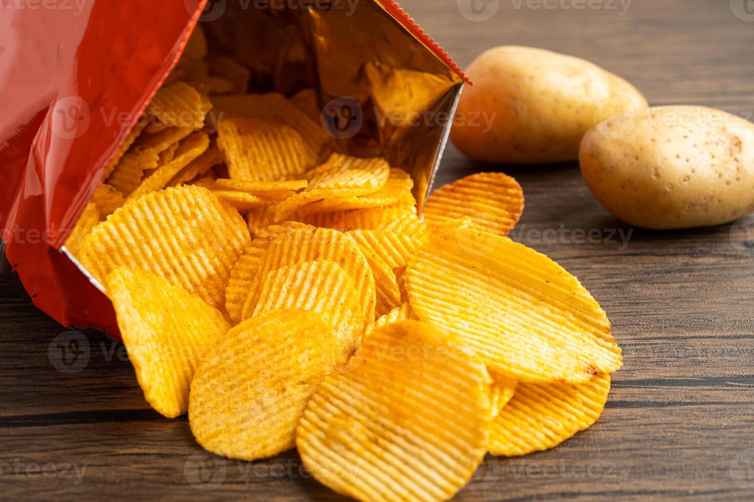 Potato chips, delicious BBQ seasoning spicy for crips, thin slice deep fried snack fast food in open bag. photo