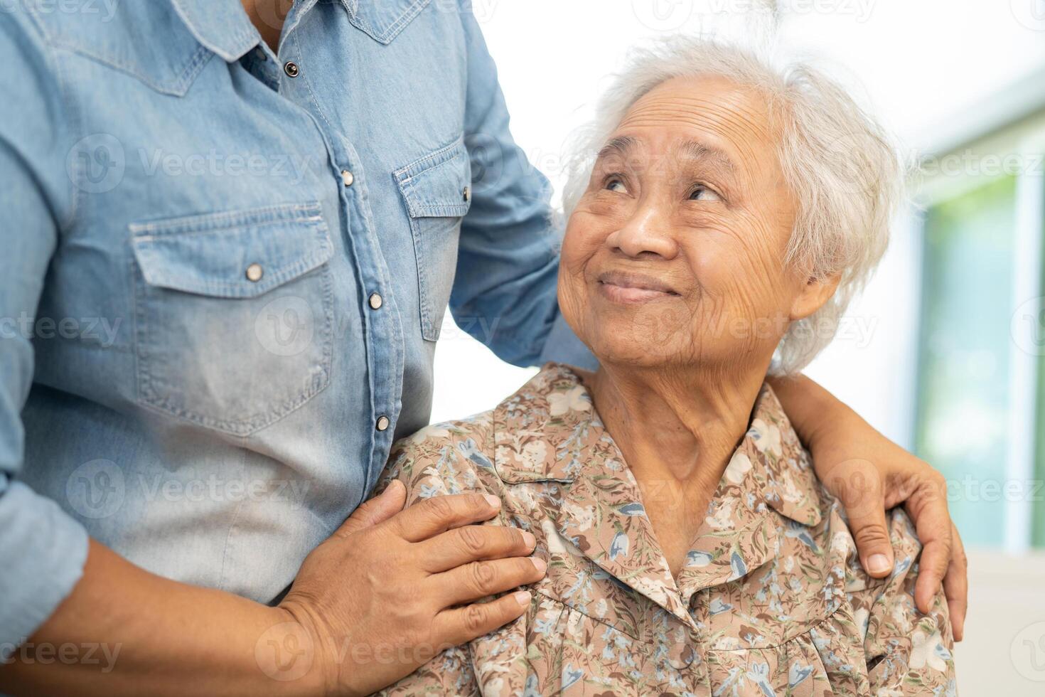 Caregiver help and care Asian senior woman patient with love, encourage and empathy in hospital. photo
