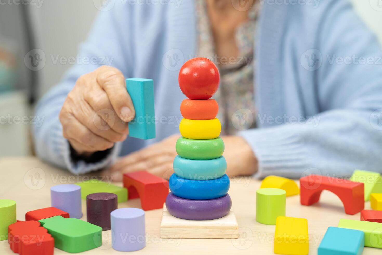 Alzheimer disease AD, Asian elderly woman patient suffering from dementia learn practical motor skills rehabilitation. photo