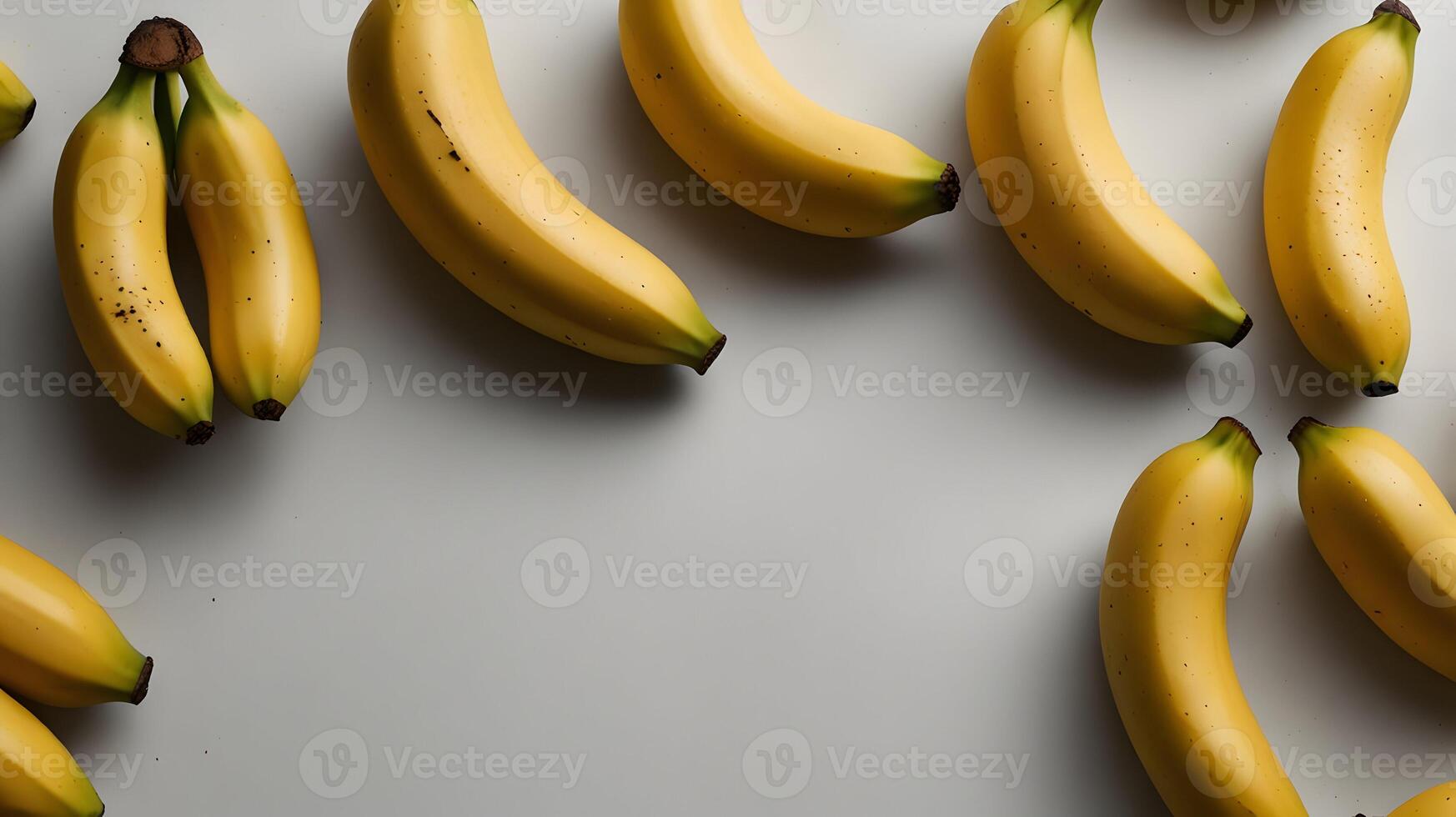 A Delightful Arrangement of Ripe Yellow Bananas on a Light Grey Background A Stunning Still Life Photography photo