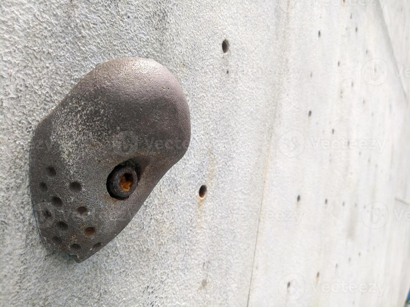 a metal object on the side of a climbing wall photo
