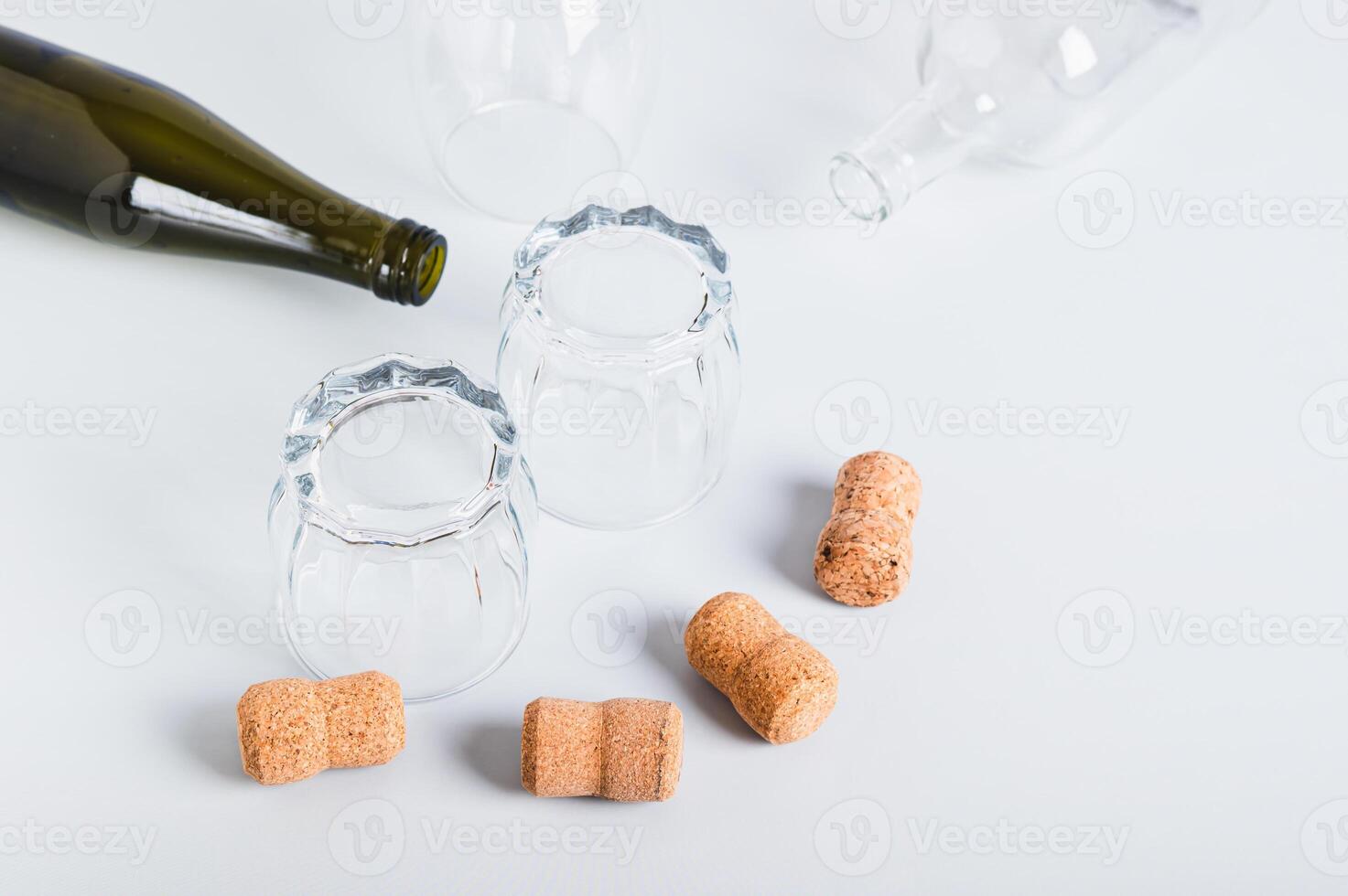 Alcoholism concept, empty glasses and bottles on grey background photo