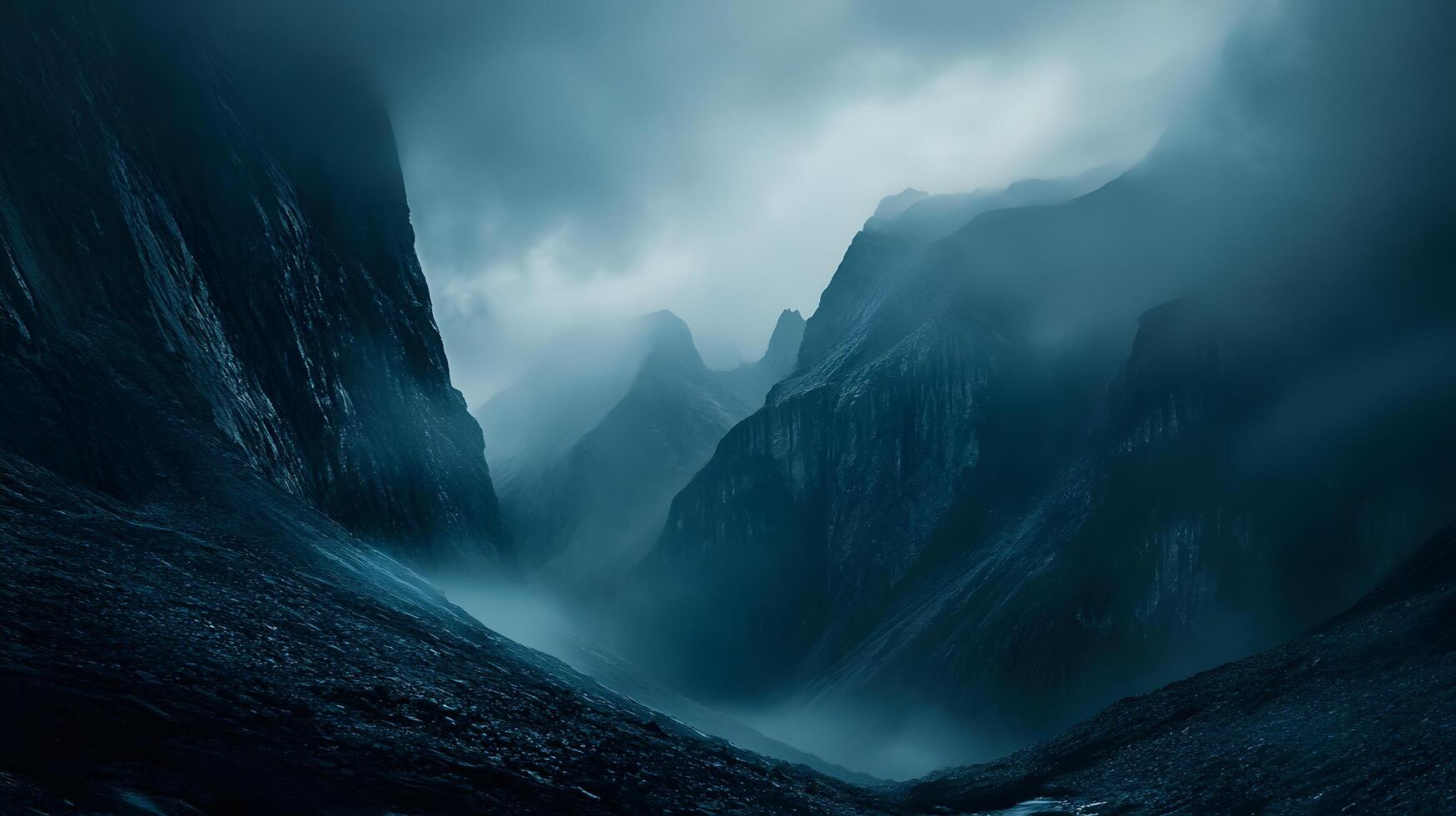 A mountain range with foggy clouds and a blue sky photo