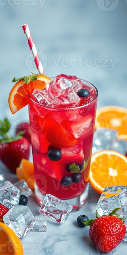Refreshing summer drink with mixed fruits and ice cubes served on a light blue background photo