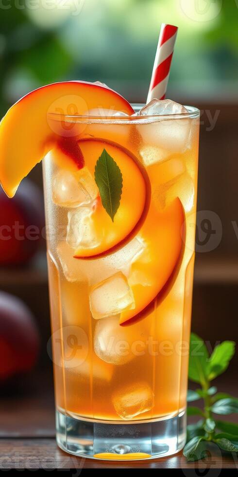 Delicious peach iced tea garnished with fresh mint leaves served in a tall glass on a warm summer afternoon photo