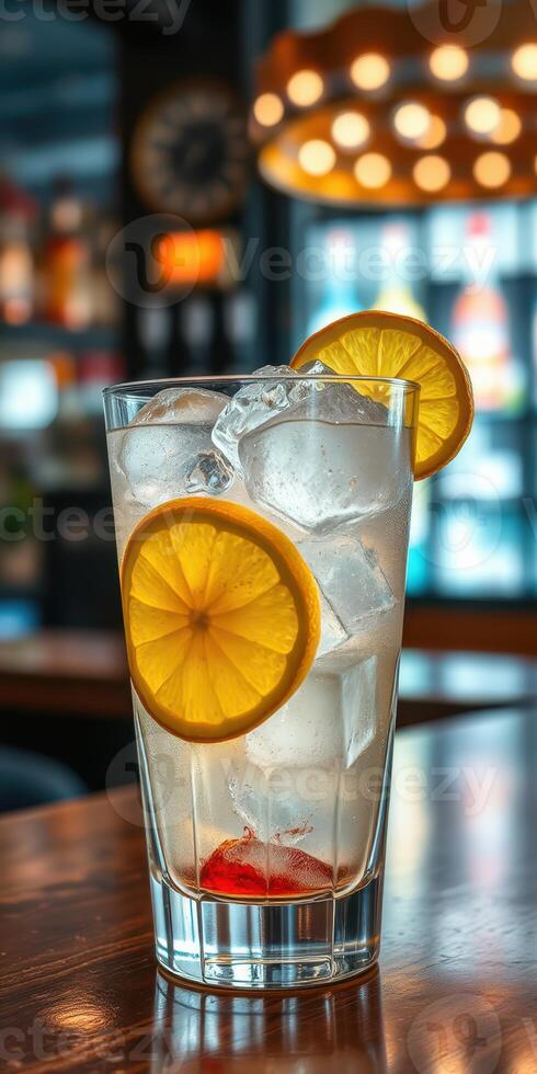 Refreshing drink with lemon slices and ice served in a modern bar setting during the evening photo