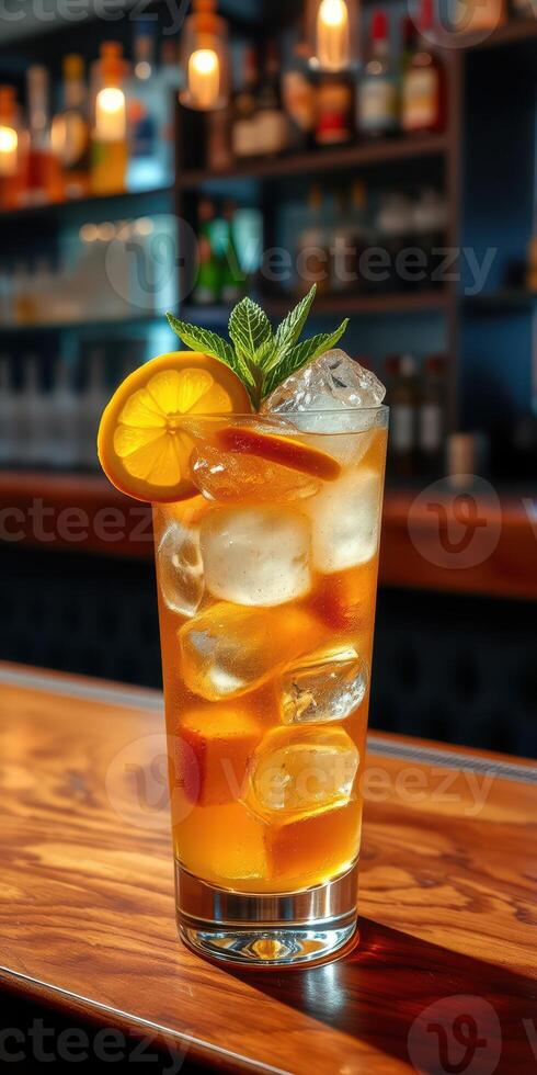 Refreshing iced beverage garnished with lemon and mint in a cozy bar setting at night photo