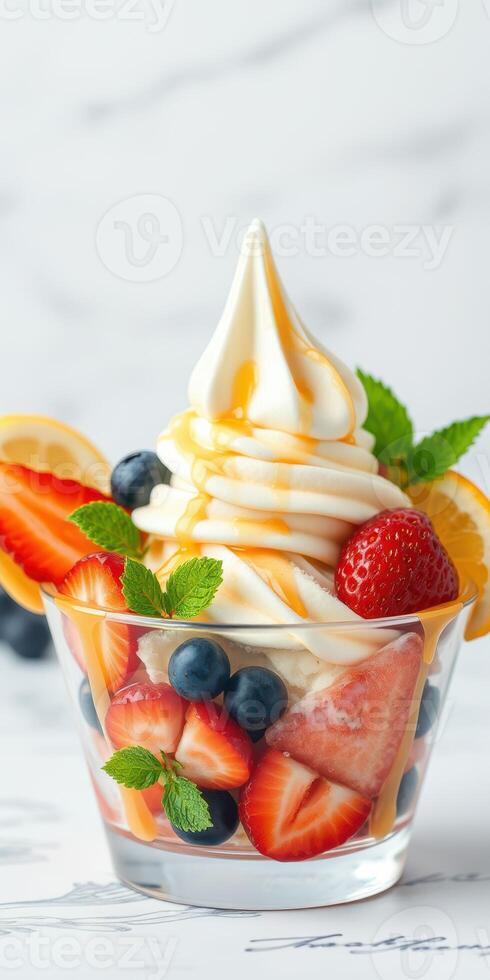 Delicious swirl of soft serve ice cream topped with fresh fruits in a clear cup at a summer gathering photo