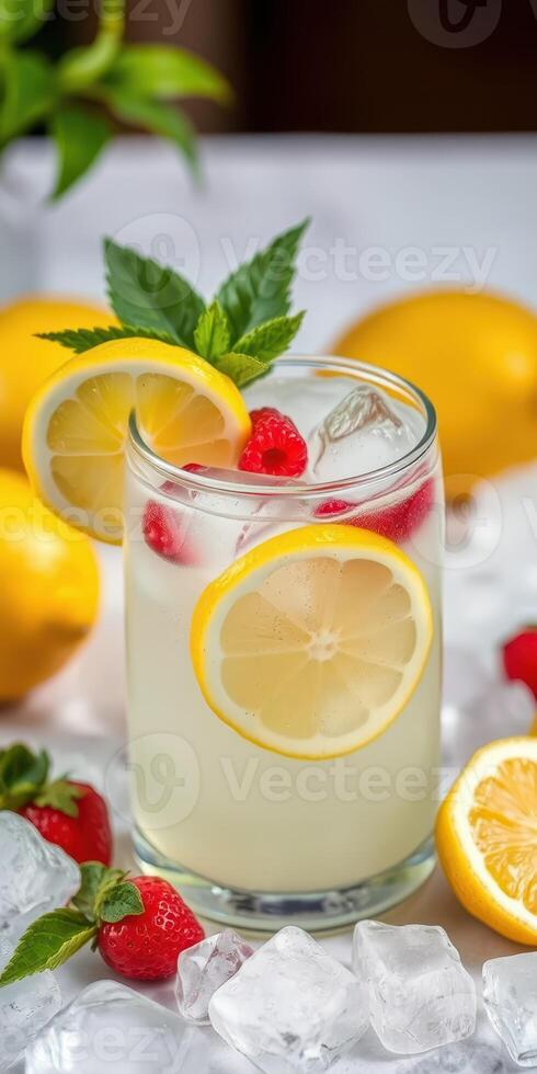 Fresh raspberry lemonade served with lemon slices and mint leaves in a glass, surrounded by vibrant lemons and raspberries photo