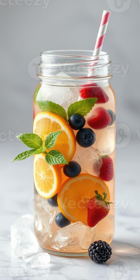 Refreshing fruit-infused drink with citrus and berries in a glass jar on a light background photo