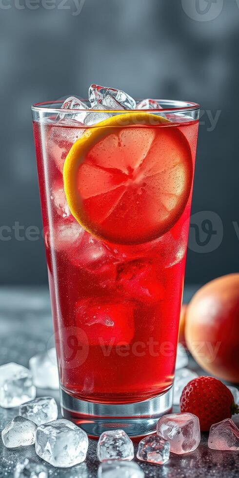 Refreshing red drink with ice and fruit garnishes on a gray background photo