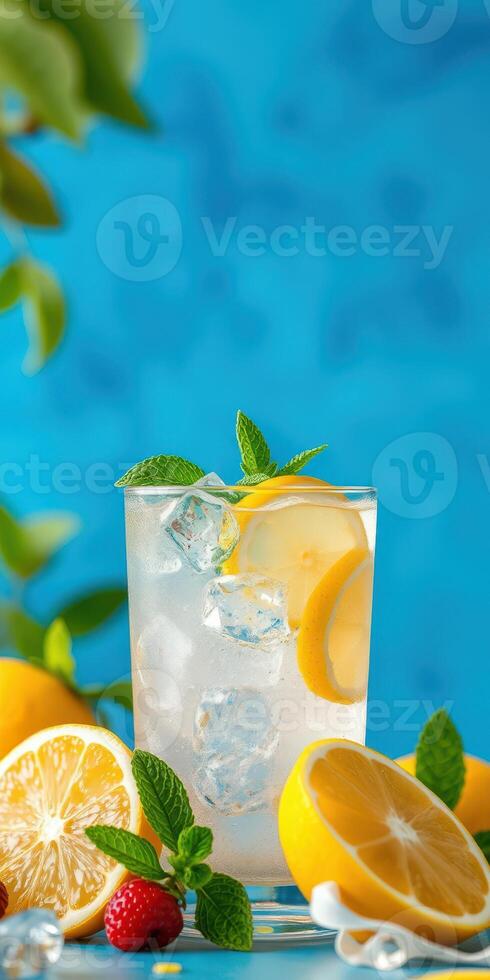 Refreshing lemon and mint beverage served over ice with vibrant blue backdrop photo