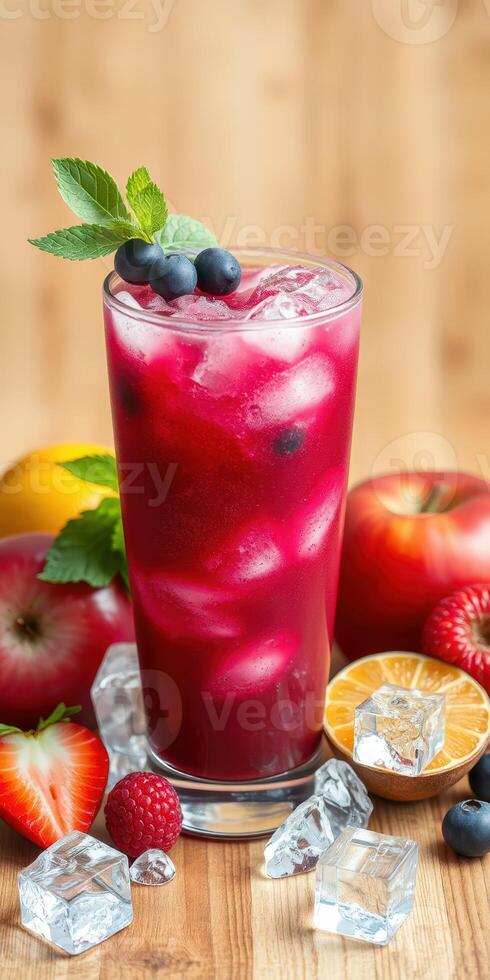 Refreshing summer berry drink with mint served in a tall glass surrounded by fresh fruits and ice cubes photo