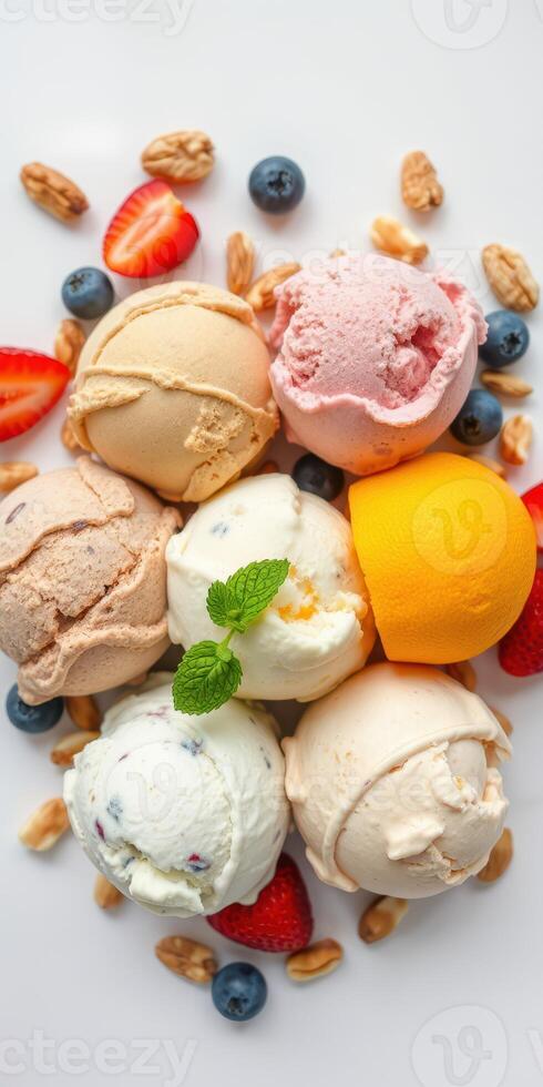 Assortment of colorful ice cream scoops with fresh fruits and nuts displayed on a white plate photo