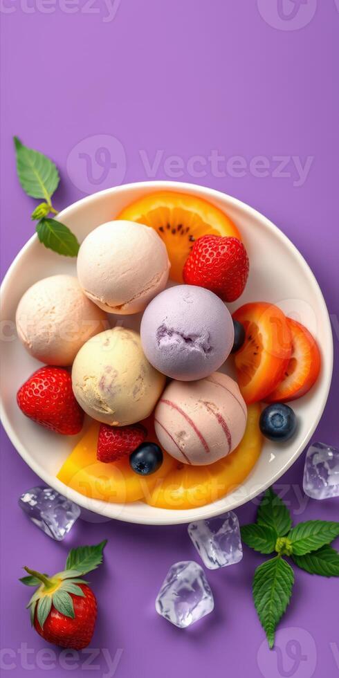 Colorful assortment of ice cream scoops with fresh fruit served in a bowl on a vibrant background photo
