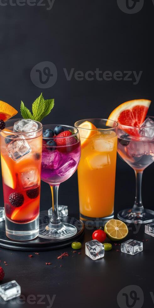Refreshing cocktail display featuring vibrant drinks with fruits and ice on a dark background photo
