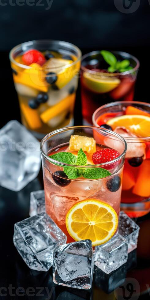 Refreshing fruit cocktails served in glasses with ice and garnished with mint leaves photo