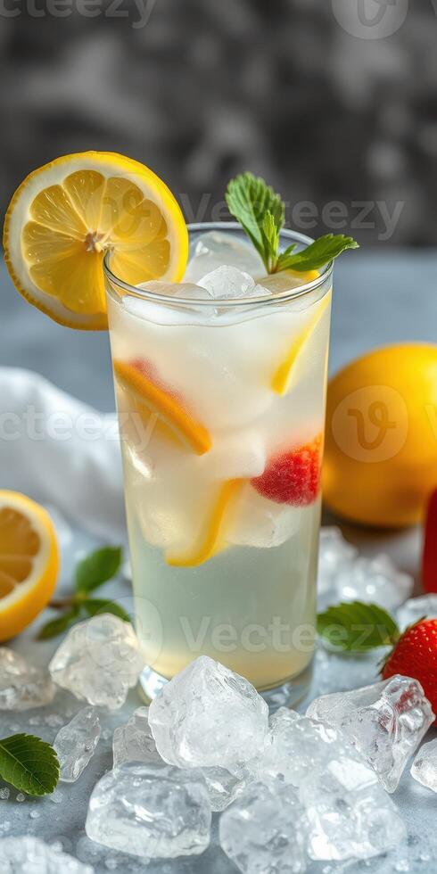 Refreshing citrus drink with lemon, mint, and strawberries served over ice on a cool background photo