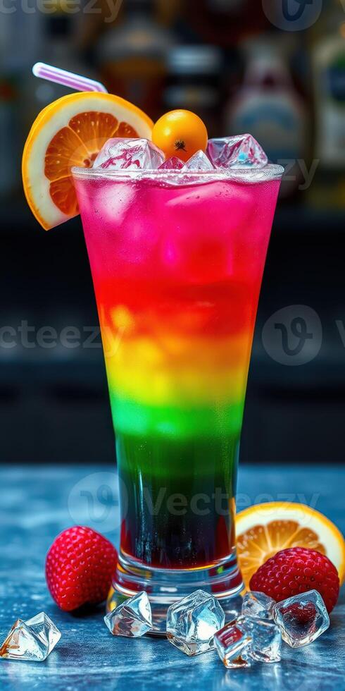 Colorful layered cocktail served with fresh fruit on a blue table photo
